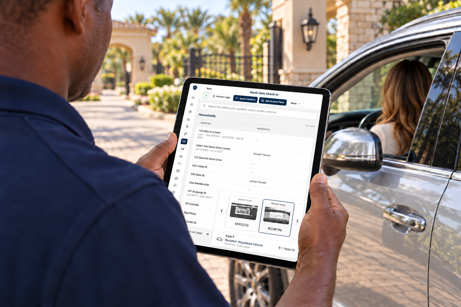 Over-the-shoulder view of a guard using GoAccess on a tablet to check in a driver at a community entrance